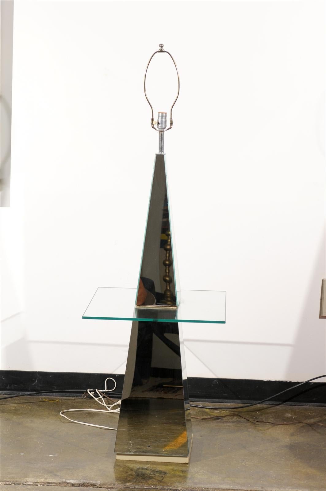 Vintage Hollywood Regency floor lamp made of mirror glass in a pyramid shape and holding a glass tabletop.