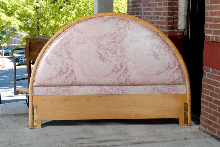 Upholstered king sized headboard of twisted rattan.