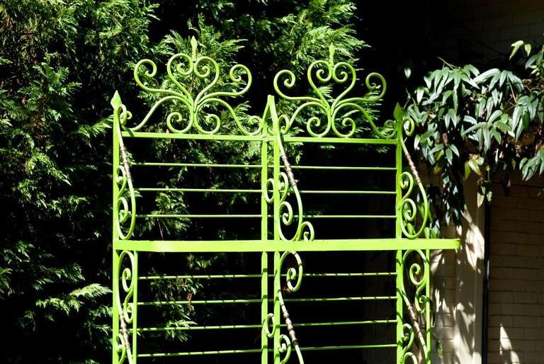 An early 20th Century French wrought iron baker's rack with brass accents that was lacquered in the 1960's to a spring green color.