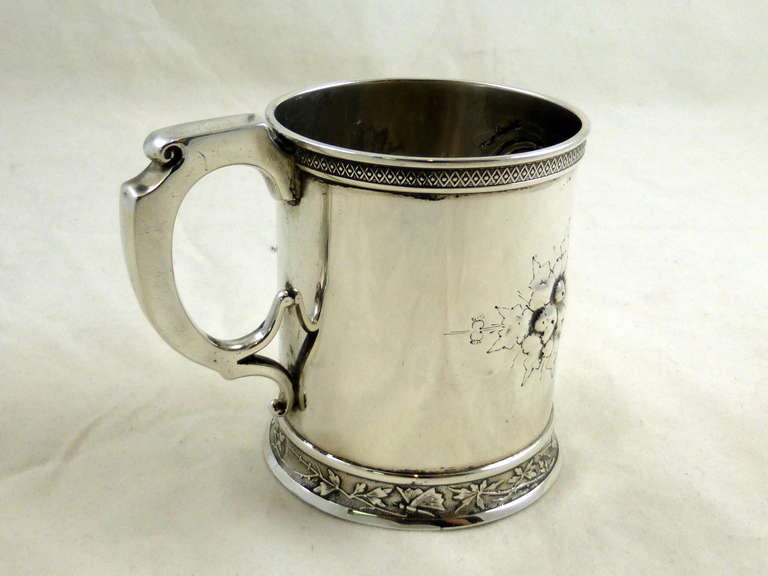 Victorian, sterling silver baby mug or cup, Wood & Hughes, New York, circa 1875. Beautiful repousse work. Vacant cartouche. Measures: 3 3/4