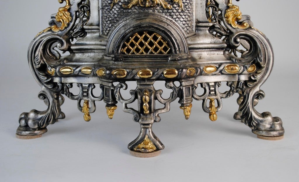 Italian Mantle Clock. Gilt decorated cast metal. Roman numerals. Key-wound. Paw feet. Vasiform finial. Center highlighted by two love birds. Mark within casting on interior wall reads “Made in Italy.” Attributed to Imperial Clock Company.