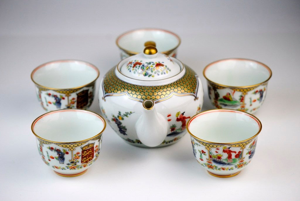 Japanese 6-Piece Kai Kai Tea Set with Heraldic Lions. Set consists of a lidded teapot and five handleless teacups. Decorated with a polychrome panel of two heraldic lions surrounded by Japanese motifs encircling the perimeters including birds,