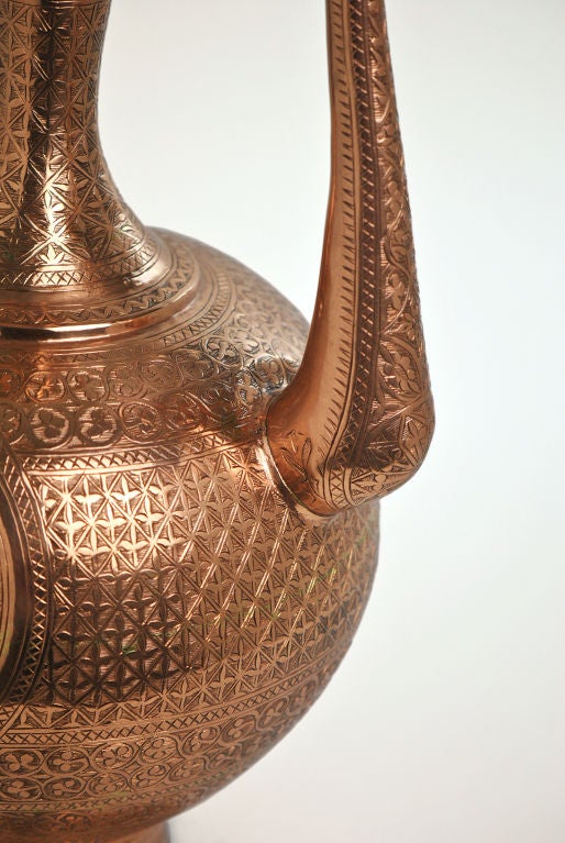 Large Copper Persian Ewer. Etched trefoil and other geometrical motifs encompass the body, base, lid, and stem. Hinged lid.