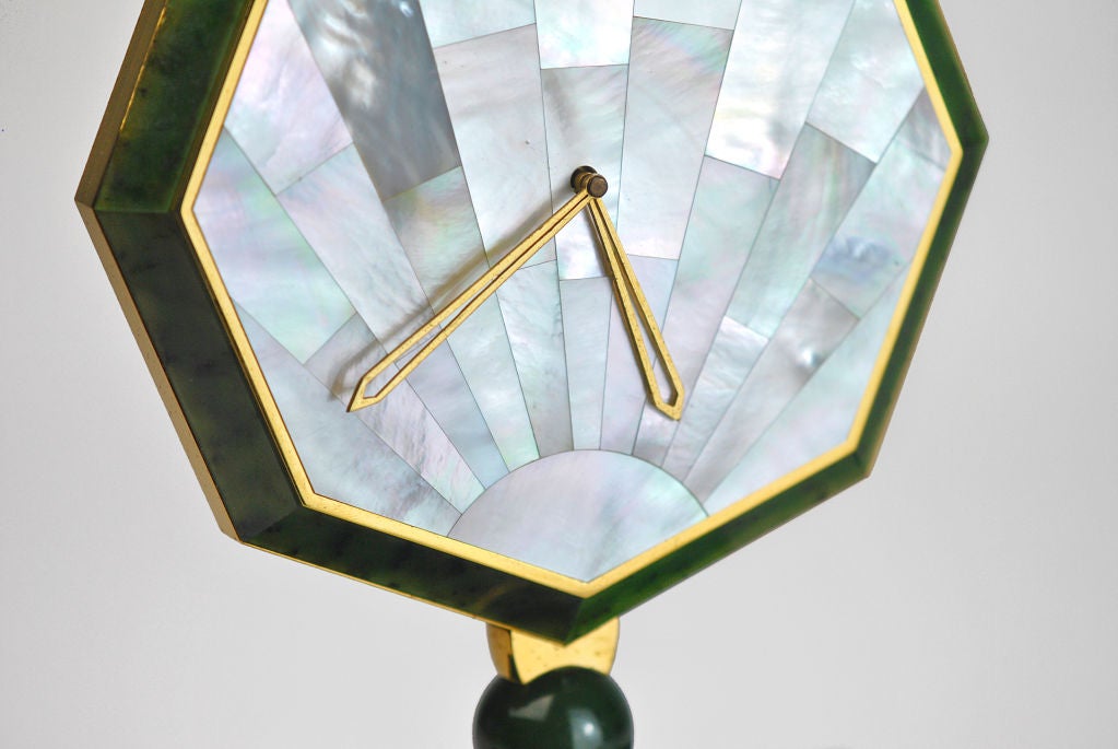 Cartier Desk Clock in the Art Deco Style. Circa 1980ï¿½s. A green hardstone, gilt-metal, and mother-of-pearl desk clock by Cartier. Octagonal case with inlaid hardstone borders, raised on a hardstone ball and stepped stem and mounted on a