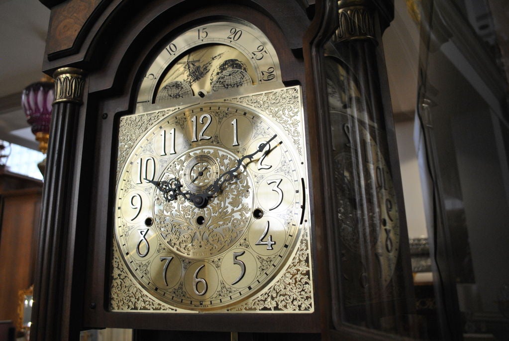 Grandfather Clock, Movement by Trend. Circa 1960’s-1970’s. Trend movement, longcase cabinetry attributed to Sligh Furniture Company. Brass dial and door mounts. Fluted pilasters. Glass sides. Original blue and gold Trend label inside door.