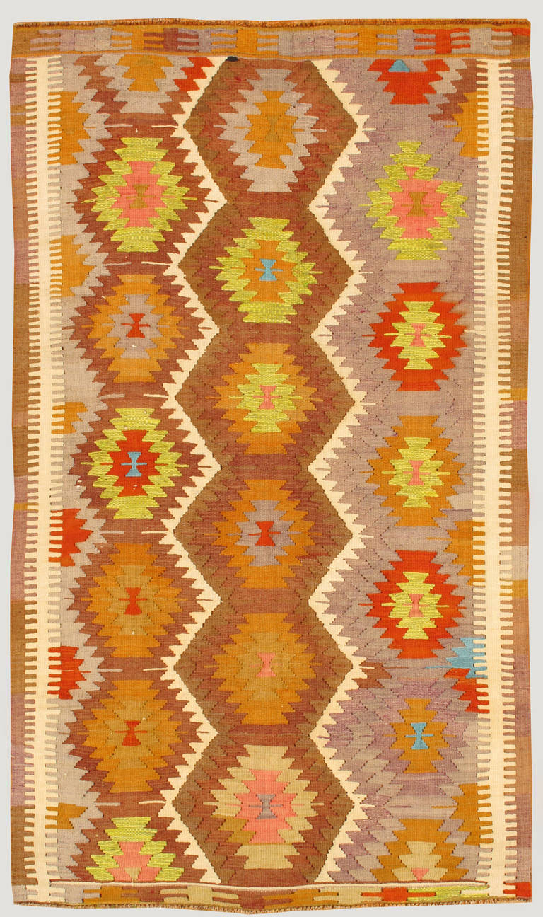 Vintage 1960's Turkish Kilim rug with a multicolored all over geometric design. Measures approximately 4 feet 3 inches by 7 feet 8 inches.
