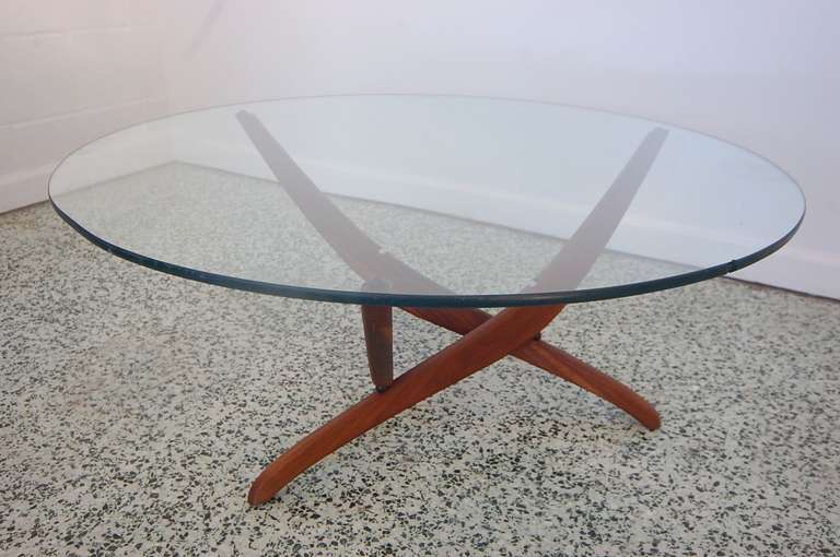Mid-Century Modern sculptural wood and glass coffee table. Unique design with classic mid-century flair.