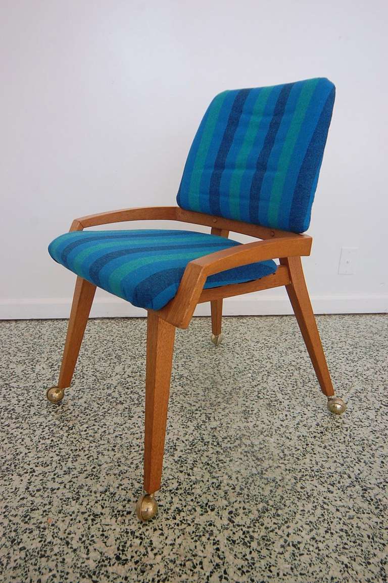 Nice mid-century small scale chair on casters with original stripe upholstery.