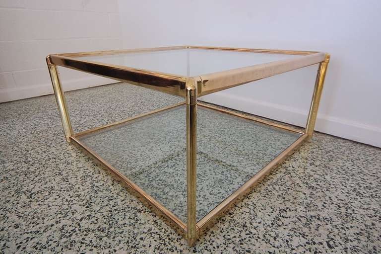 Very nice gold and glass vintage coffee table with two glass shelves. Beautiful classic design. Very versatile piece.