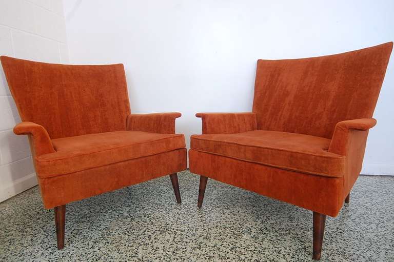 Nice pair of Paul McCobb attributed lounge chairs with slight wingback design. Original burnt orange upholstery in good condition.

arm height is 19.5