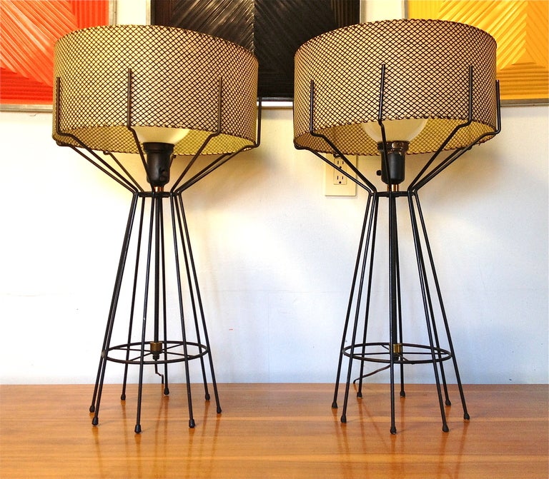 Pair of amazing mid-century original Arthur Umanoff iron frame table lamps with original drum shades.
