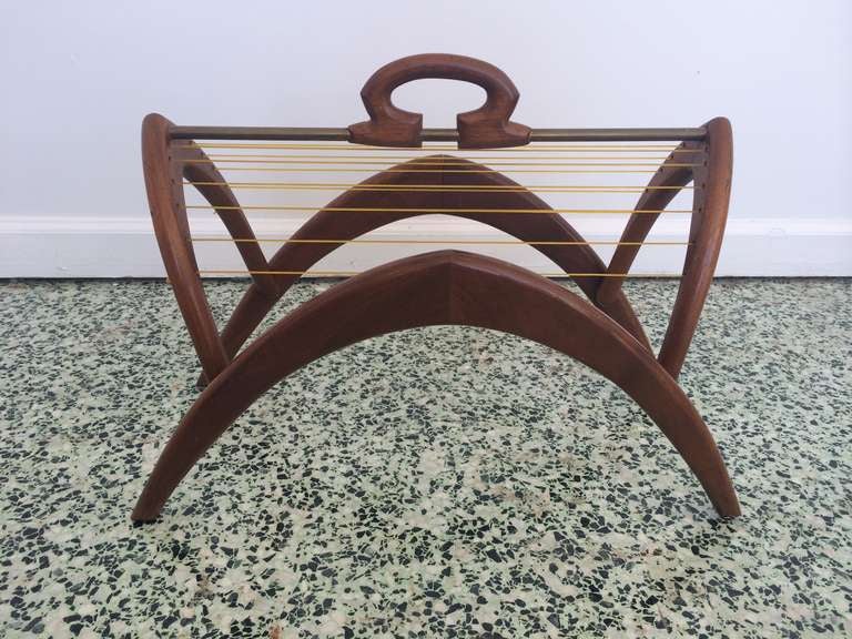 Beautiful sculptural Mid-Century magazine rack with wire holders and wood frame.