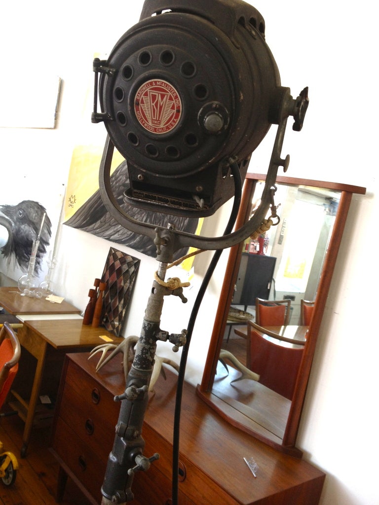 Mid twentieth century movie spot light. this light makes an impressive industrial, statement. On rolling, tripod stand telescope at two levels to a height. All original. 