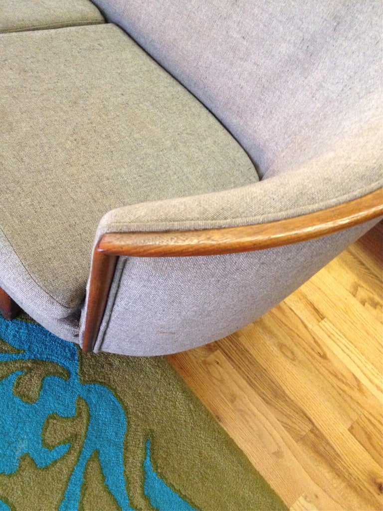 Very nice curved mid-century sofa with teak wood trim. 