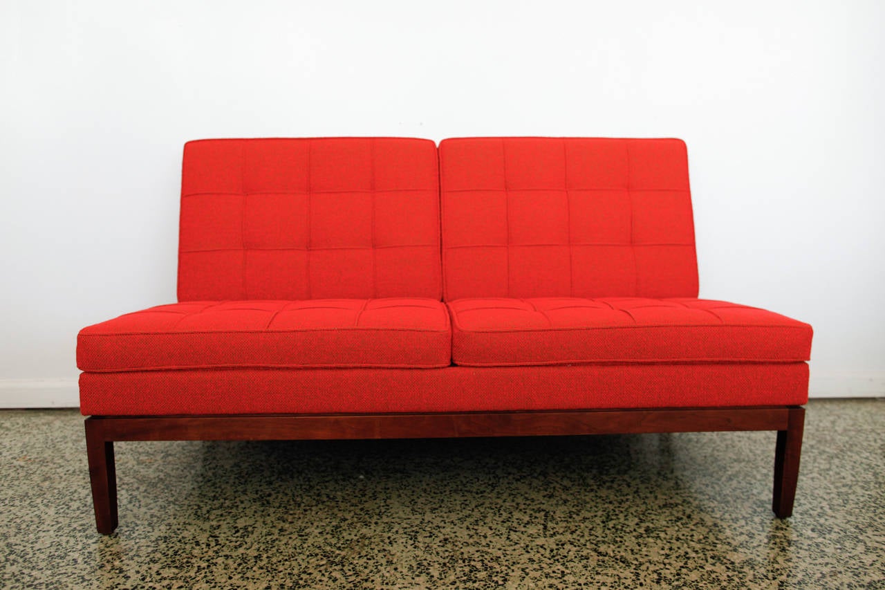 Very nice Mid-Century Modern florence Knoll settee sofa newly upholstered in this vibrant orange red upholstery. Very nice walnut wood base. We have a longer version available as well.