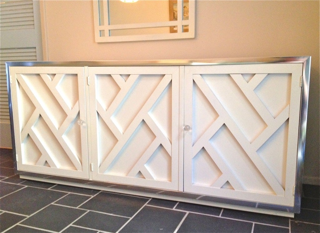 Beautiful Chippendale style white credenza with Lucite pulls and mirrored accents.  Matching dining set also available-6 chairs and table.