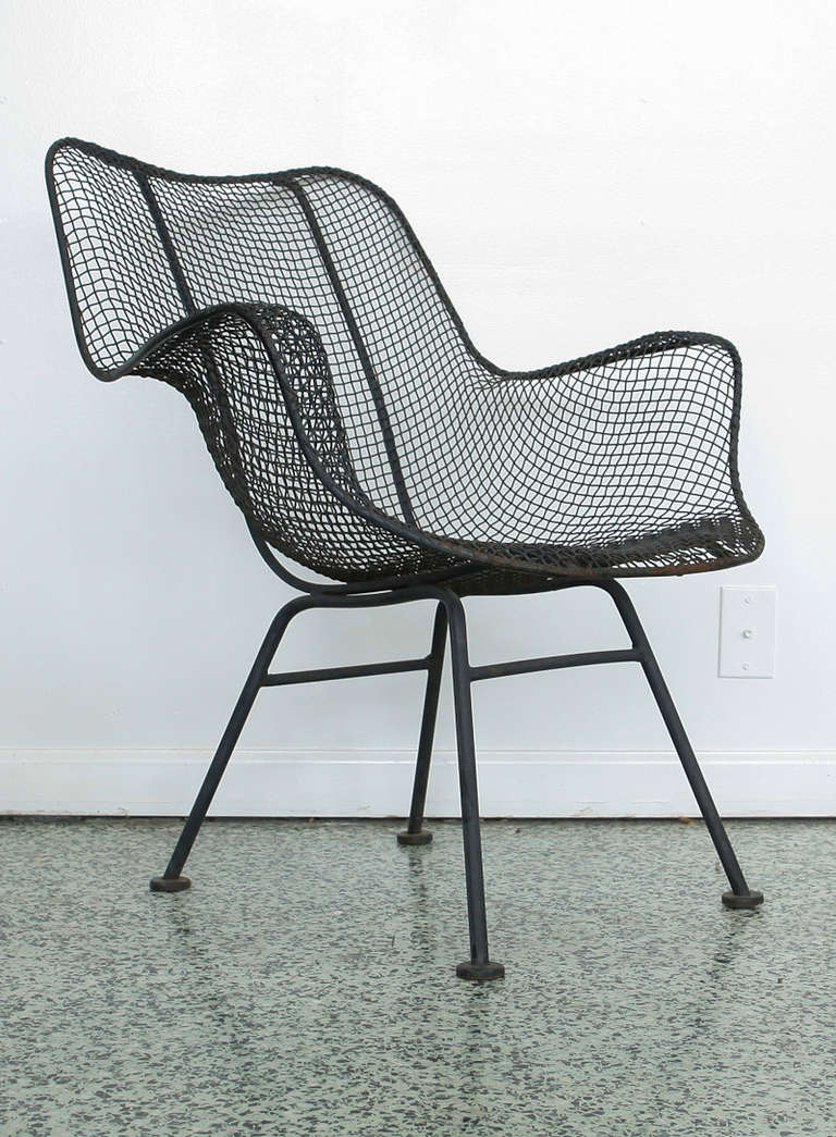 6 sculptural and organically-shaped patio arm chairs in black steel mesh and iron by Russell Woodard for his Sculptura collection. We have 2 side chairs also available.