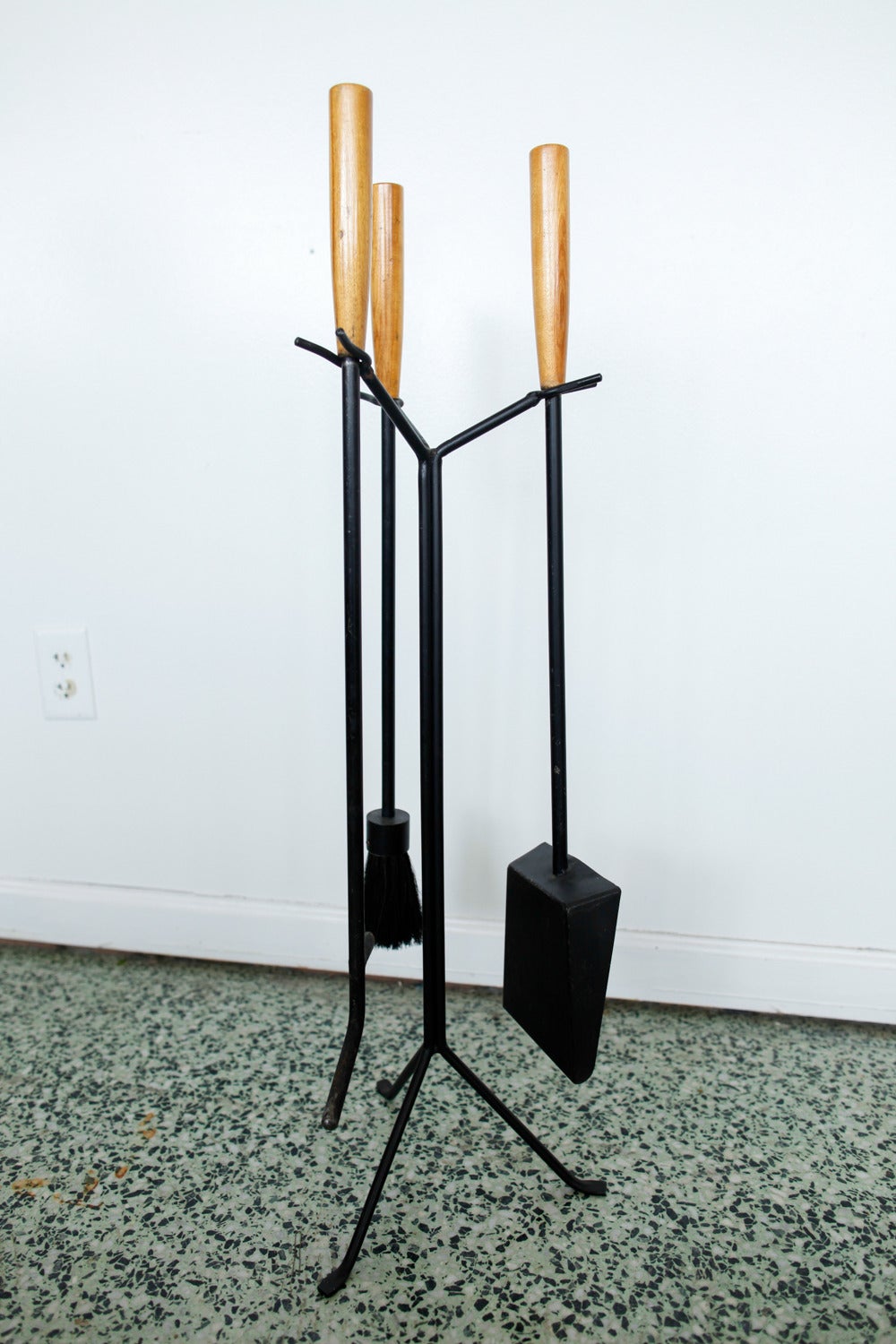 Rare and iconic painted or enameled iron and birch fireplace tool set designed by George Nelson for the Howard Miller Company. Listing includes Stand, brush, shovel, and poker. Very nice Mid-Century addition to your decor. 

Construction: Metal,