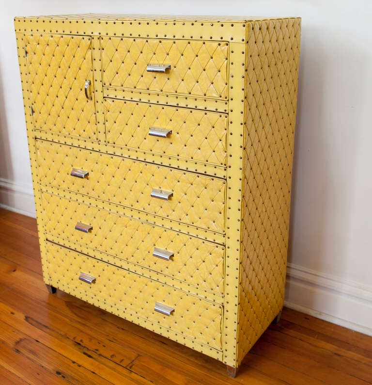 Very unique mid-century vinyl tufted upholstered wood storage unit with 4 drawers and one door. Chrome metal pulls.