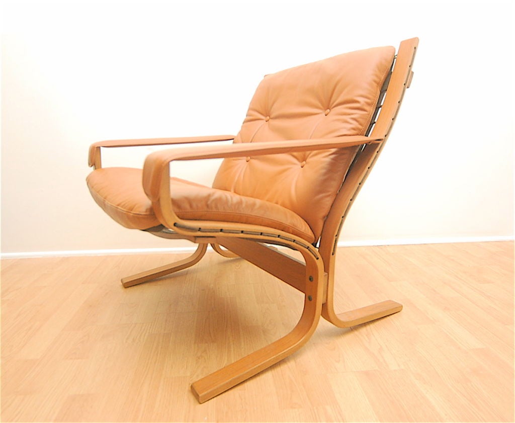 Ingmar Relling  for Westnofa leather lounge chair. Bent rosewood frame, sail cloth tied into frame with tan leather cushions. 1965.