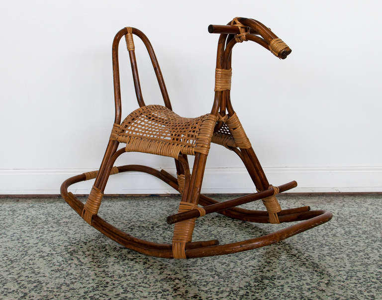 Rattan rocking horse with a cane seat as an abstract sculpture. Swedish-made, late 1950s to early 1960s. Remains its original label.