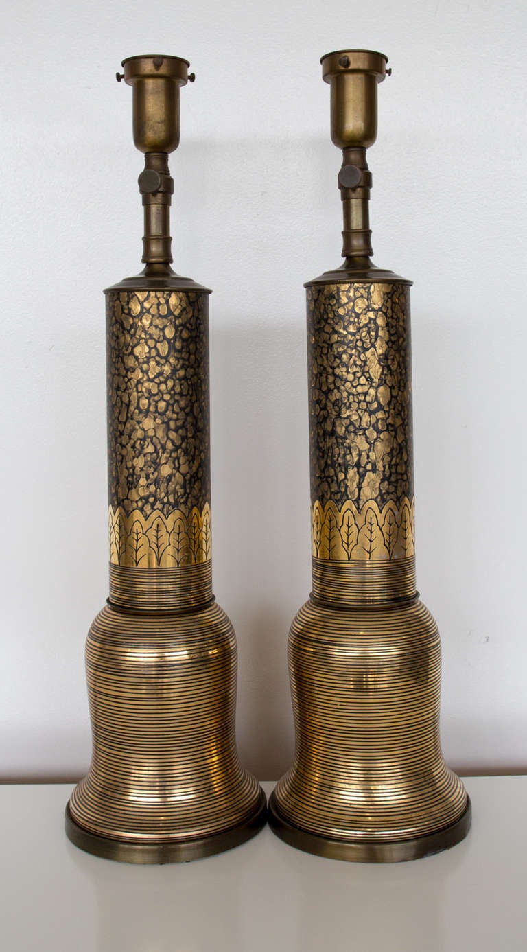 Stunning pair of Hollywood Regency gold and black table lamps. Very nice condition. Working order. No shades.