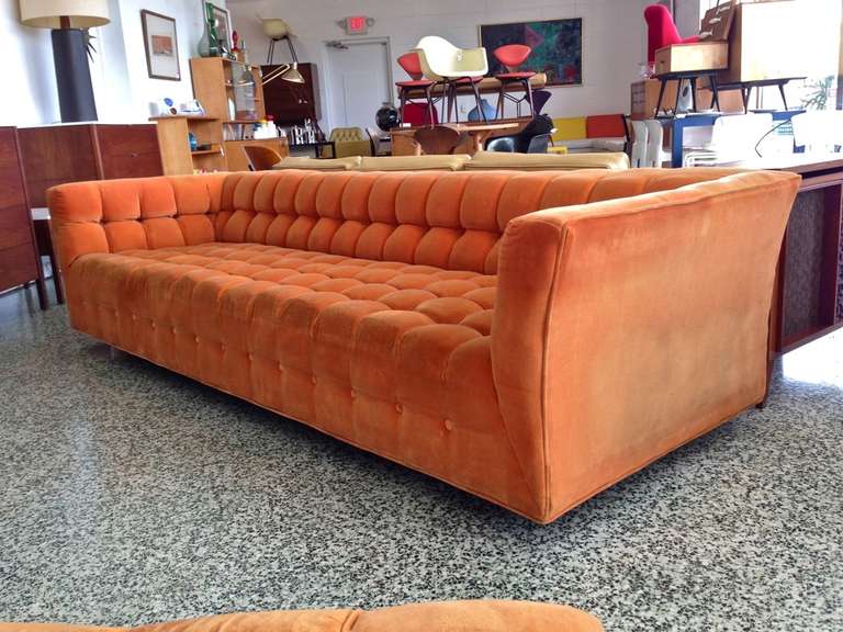 Large button tufted sofa with oversized ottoman. Original orange upholstery.