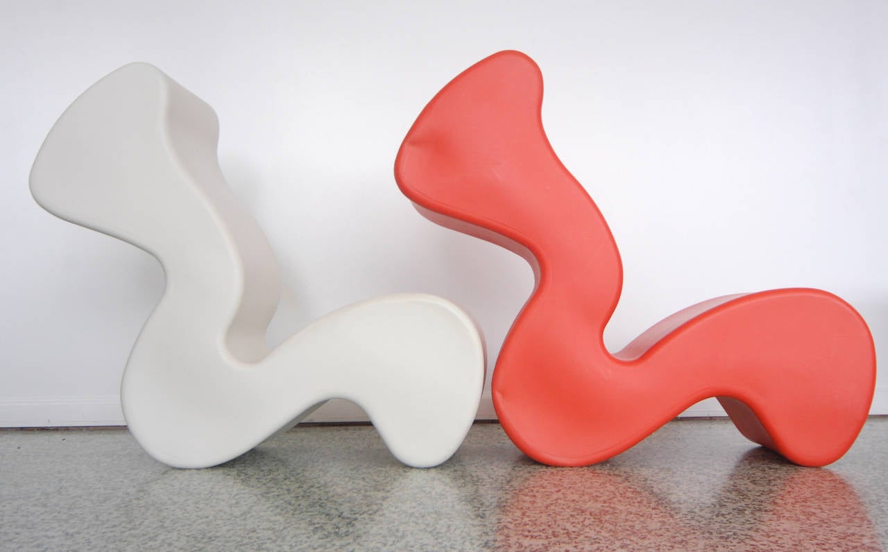 Multiuse chair, bench, table designed by Verner Panton. By rotating the form you can change its function; high back lounge chair, deep seated lounge chair, two seated bench, table. Lay flat or upright. One red and one white.