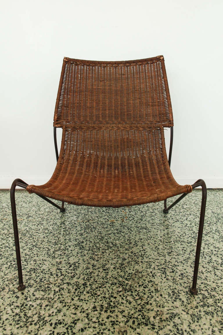 Pair of Frederick Weingberg iron and wicker sling chairs with metal frame.