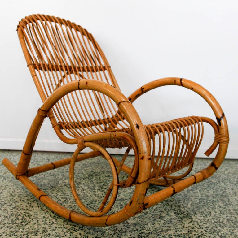 Mid-Century Italian rocking chair in bent rattan, graceful style of Franco Albini. These late 1950s patio chairs are in excellent vintage condition.