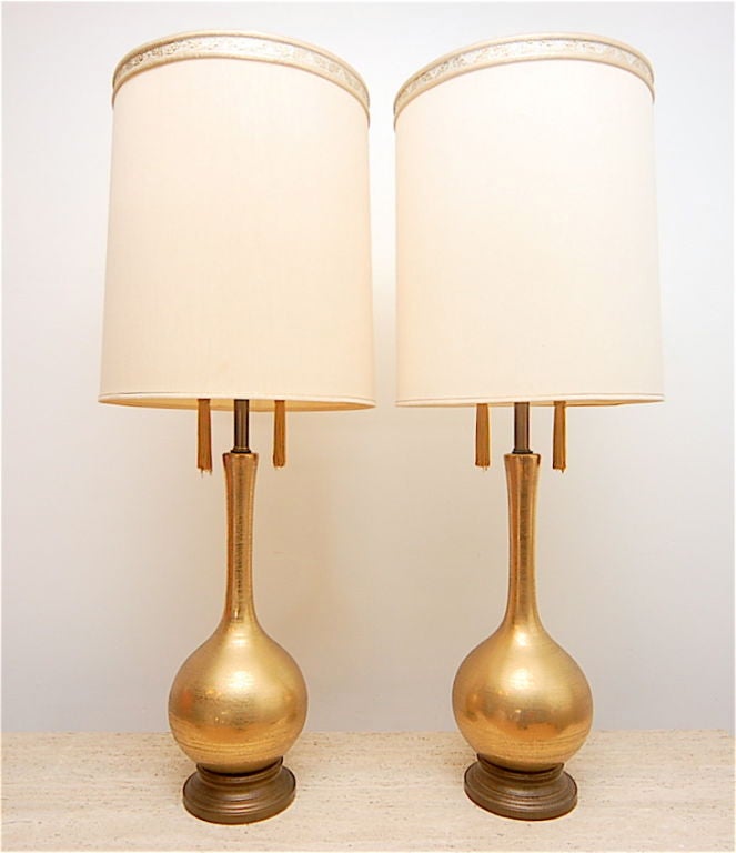 Gold crackeld ceramic lamps with original gold metal base. Matching gold tassels for pulls.