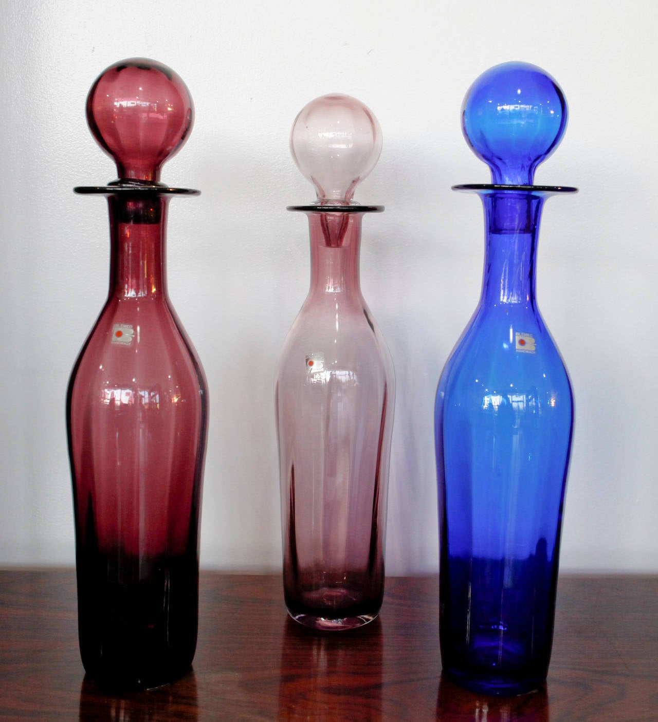 Tall architectural scale organic shaped cobalt blue, red and rose decanters with complimentary stopper by Blenko.
