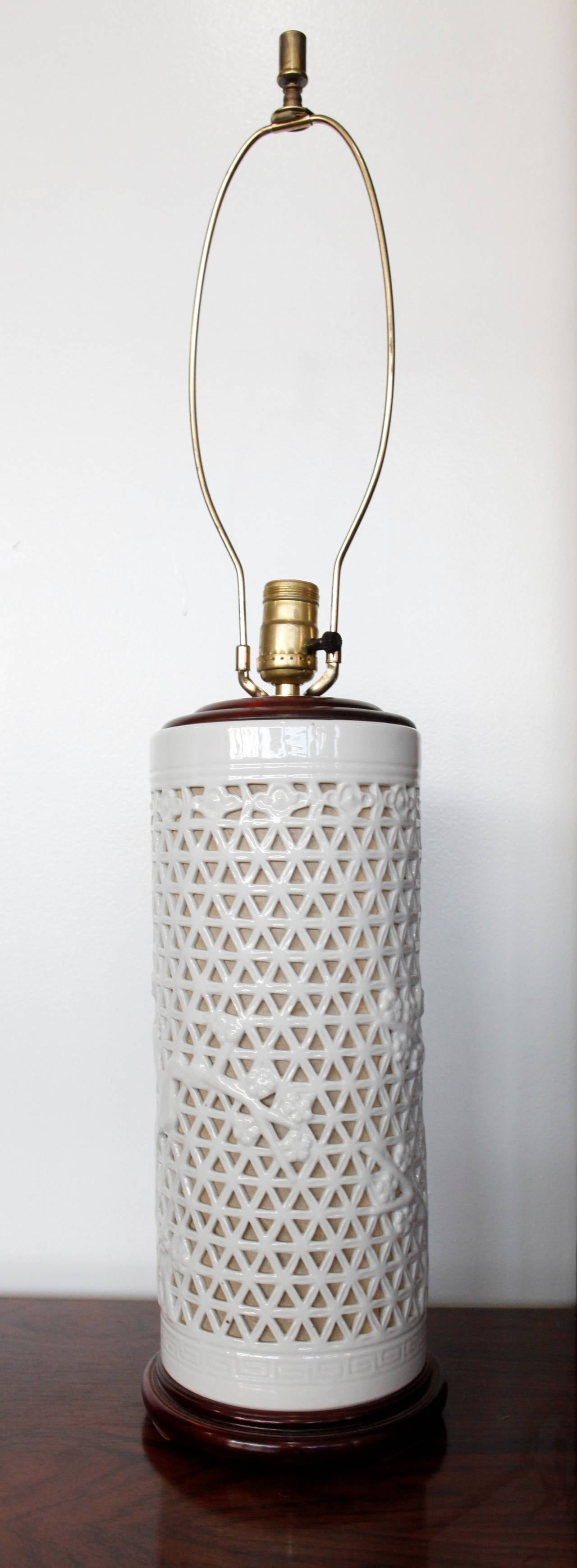 Pierce cut ceramic Blanc de Chine table lamps with cherry tree motif.
