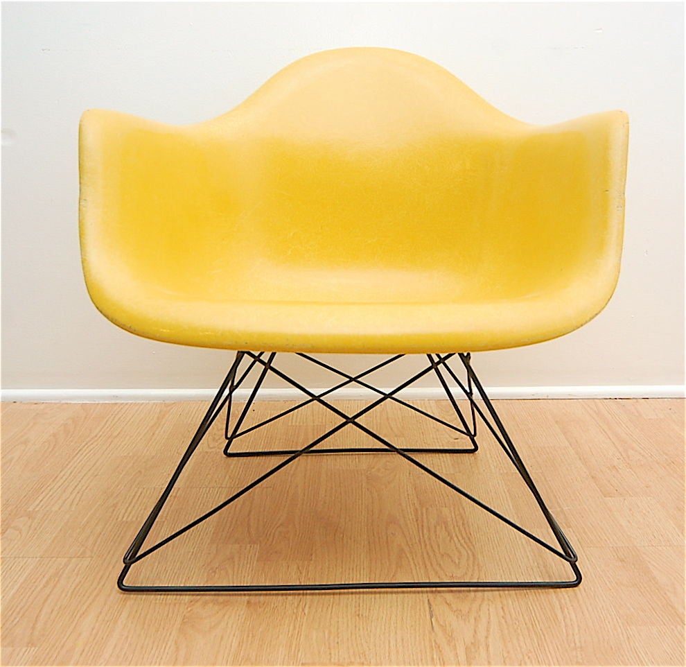 Eames for Herman Miller arm shell chair with original cat's cradle base.