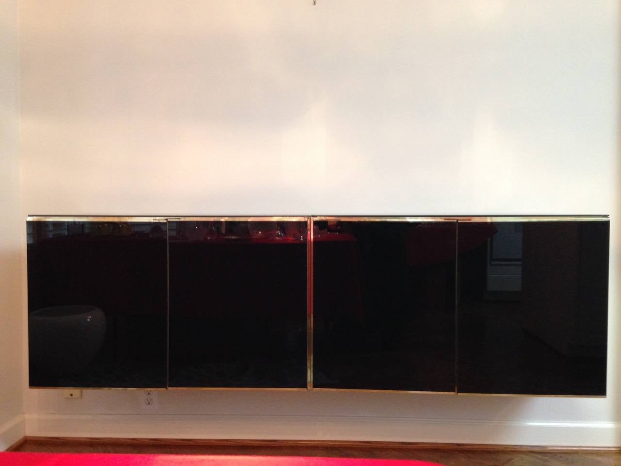 Sophisticated Ello floating black and gold credenza. This piece is comprised of two individual pieces put together.