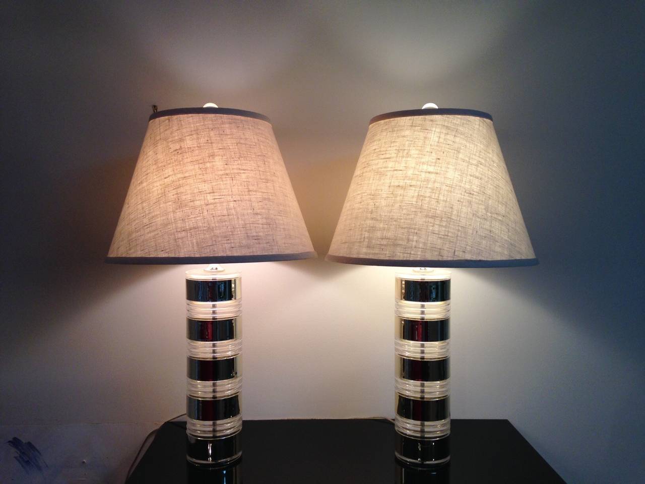 Beautiful pair of Optique lamps with Lucite and brass base and custom-made shades. Beautiful condition. In working order.