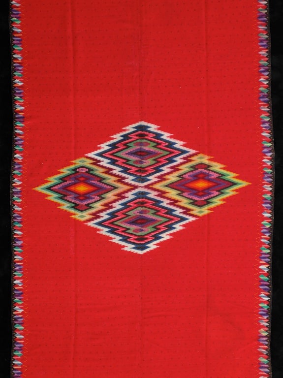 Typical features of these blankets are the use of aggregate diamond, an open field usually filled with a repeat dot pattern, and sawtooth borders terminating in horizontal lines. Although one can't be certain of the origin of this serape it has