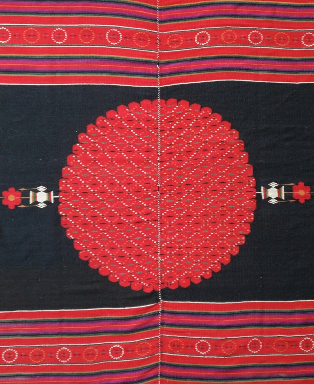 Handwoven in 2 matching panels large blanket in mint condition. Large central medallion on a solid black field with horizontal stripes on both ends. Note the 2 flower pots in the tri color of the mexican flag with a small flag on top of the large