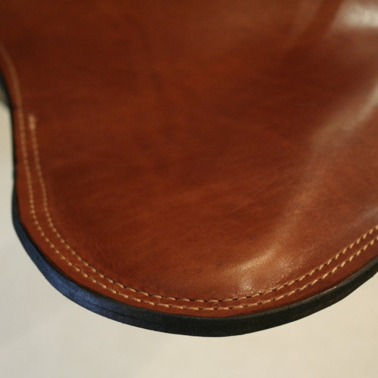 A true modern iconic piece of art!  The high quality leather and the craftsmanship of the chair will last a lifetime. The seat cover is made from premium Argentinean leather pieces in a rich cognac hue. Beautifully sewn together, every seam and edge