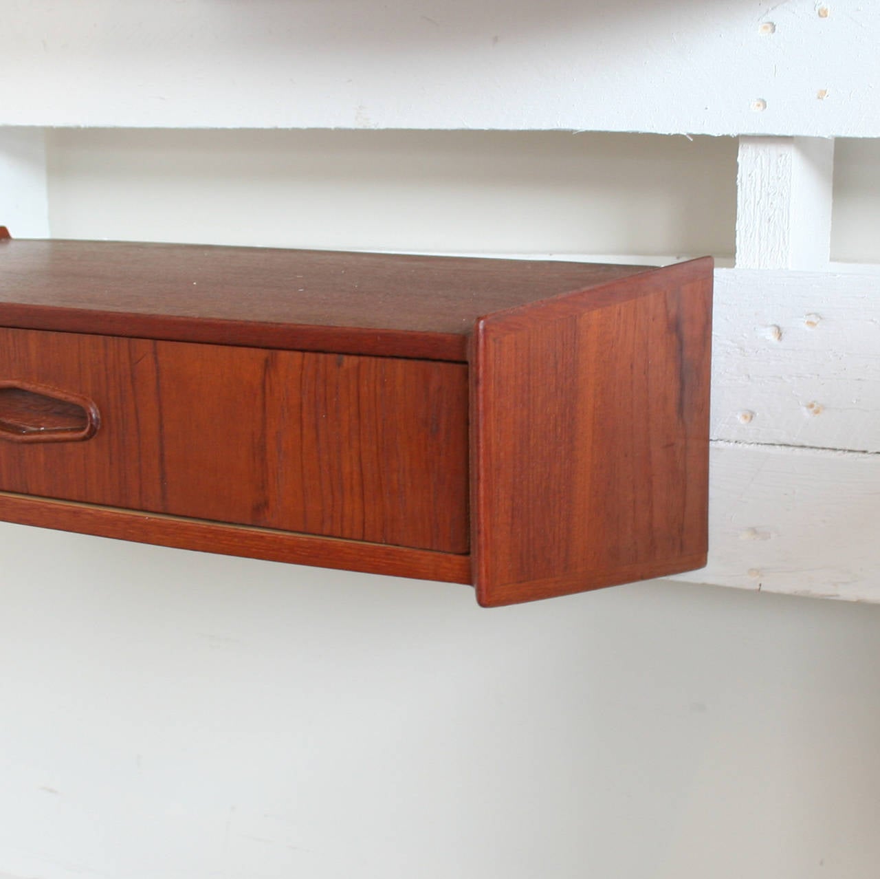 Pair of teak wall mounted drawers with solid teak diamond shaped pulls. Two available, sold individually.