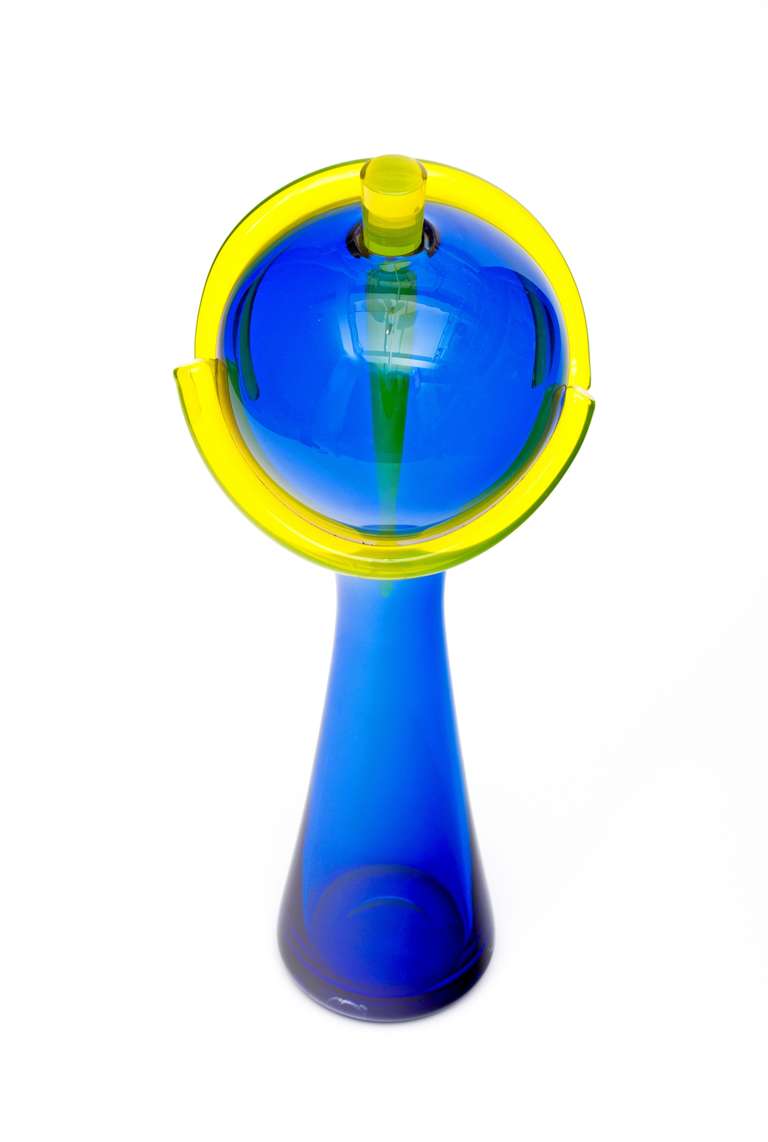 Stunning and dramatic handblown blue glass sculpture with a yellow stopper by artist John Chiles, circa 1997. Known as Around the World this is a dramatic stand alone piece!  Large scale and very impressive to the eye!



