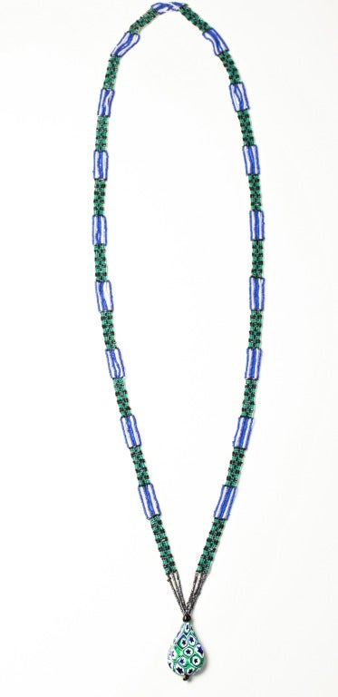 A Stunning Art Deco Sautoir or Flapper Necklace constructed of green, blue and black glass seed beads with a Millefiori Art Glass Pendant. All original and in excellent condition with original cotton stringing. Millefiori Pendant is 5 inches long
