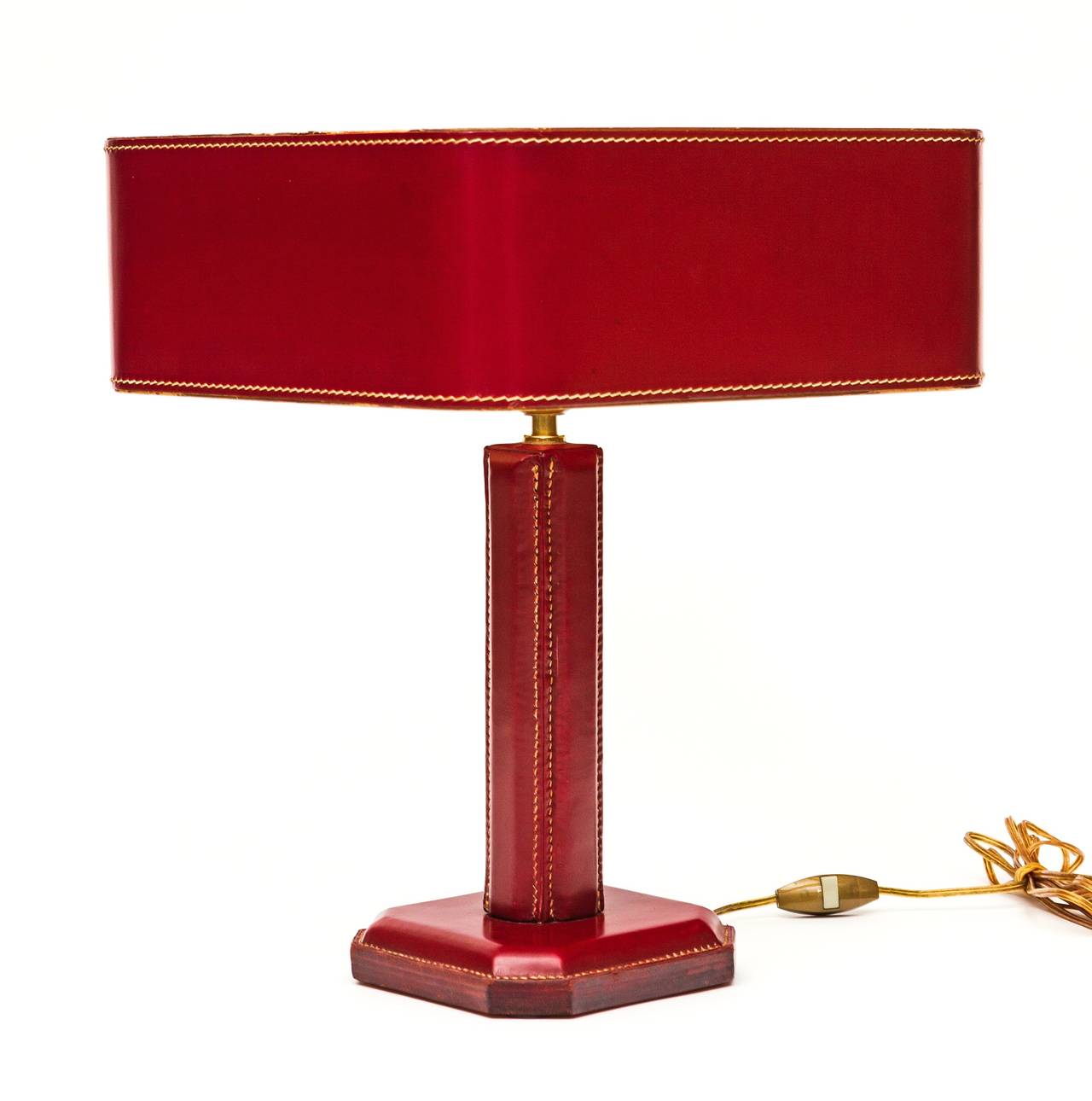 Striking Jacques Adnet table or desk lamp with hand-stitched leather base made of multiple layers with period hand-stitched square leather shade. Attributed to Jacques Adnet for Hermès. Rewired, unsigned, marked handmade.

Shade is 12.75