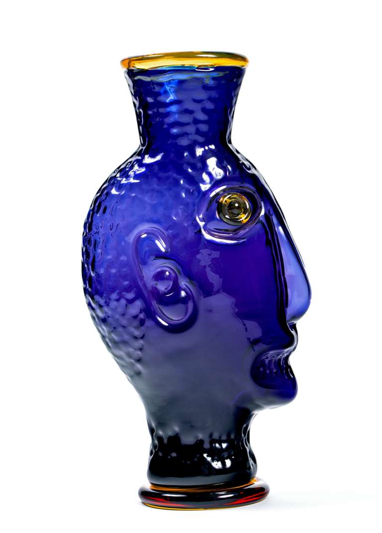 A great piece of art by master glass artist Hank Murta Adams  in a rich cobalt blue with warm yellow/topaz eyes and trim. A striking vase that was created when Adams was artistic director at Blenko from 1988 until 1994.  

He received a BFA from