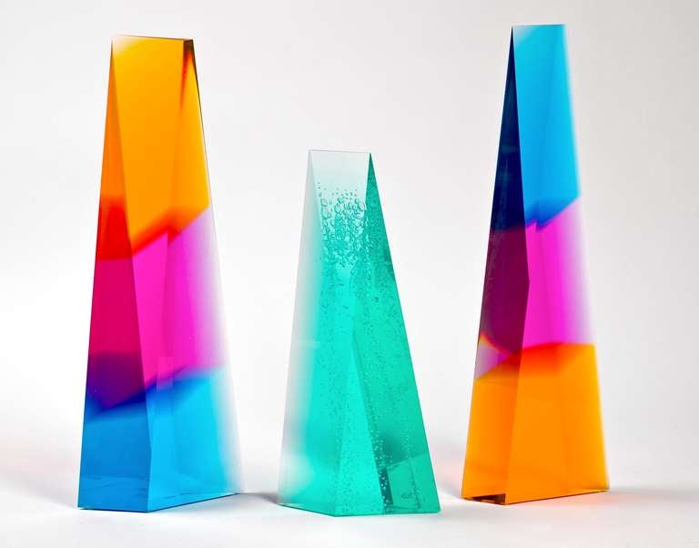 Lucite sculptures by renowned New York artist Norman Mercer. Two extra large tri-colored sculptures have reverse Blue, Pink and Gold colors and one Green Sculpture features controlled bubbles.  Each sculpture is a three-dimensional piece of art that