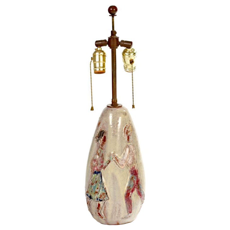 In the manner of Fantoni, this great lamp vibrates with the dance of young lovers being serenaded by an outdoor musician. Great craftsmanship and beautiful condition for a true period piece.
Measures: Base is 12.50 inches high. Lamp height is 22