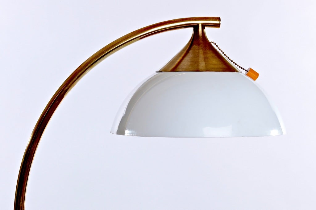An original Russel Wright curved Bamboo and Brass Floor Light with signature underneath on metal base and a bakelite pull.  The original shade was replaced with a later shade.