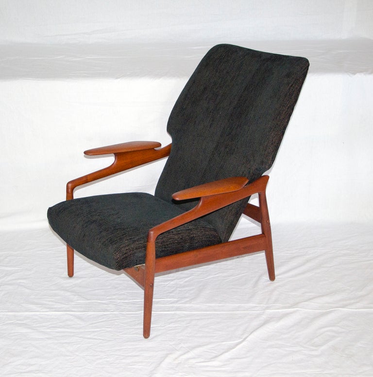 Finn Juhl style reclining lounge chair. Has manually operated mechanism under seat. Chair has small brass inlays typical of Grete Jalk or Illum Wikellso construction. Upholstery is black textured fabric Re-upholstery available ( $175 plus three