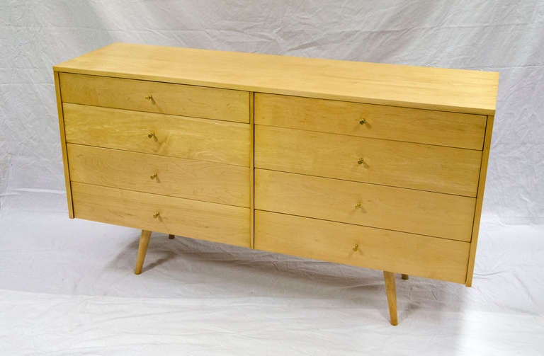 Spacious dresser with eight drawers designed by architect and furniture designer Paul McCobb. Dresser style is part of the Planner Group manufactured by Winchendon Furniture Co. Winchendon, Mass. Dresser retains original foil tag in top left drawer.