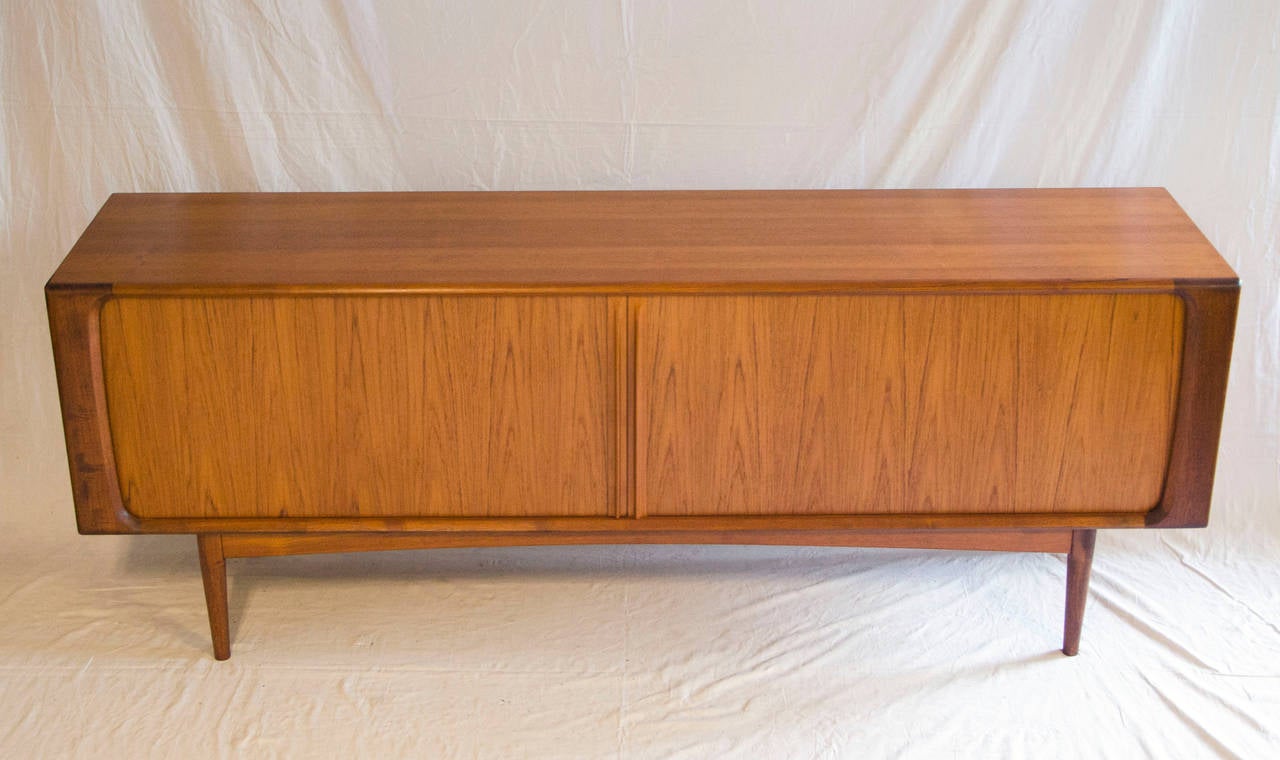 Beautiful Danish teak credenza with tambour doors, supported by a 12